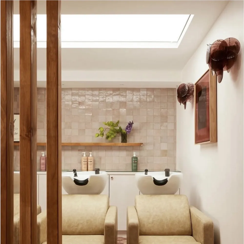 Hair salon wash chairs behind a timber screen
