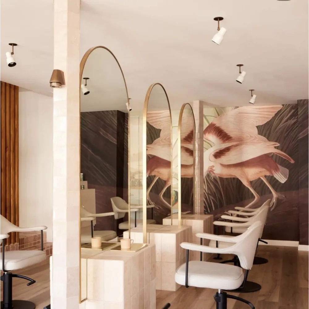 Hair salon styling stations with arched mirrors